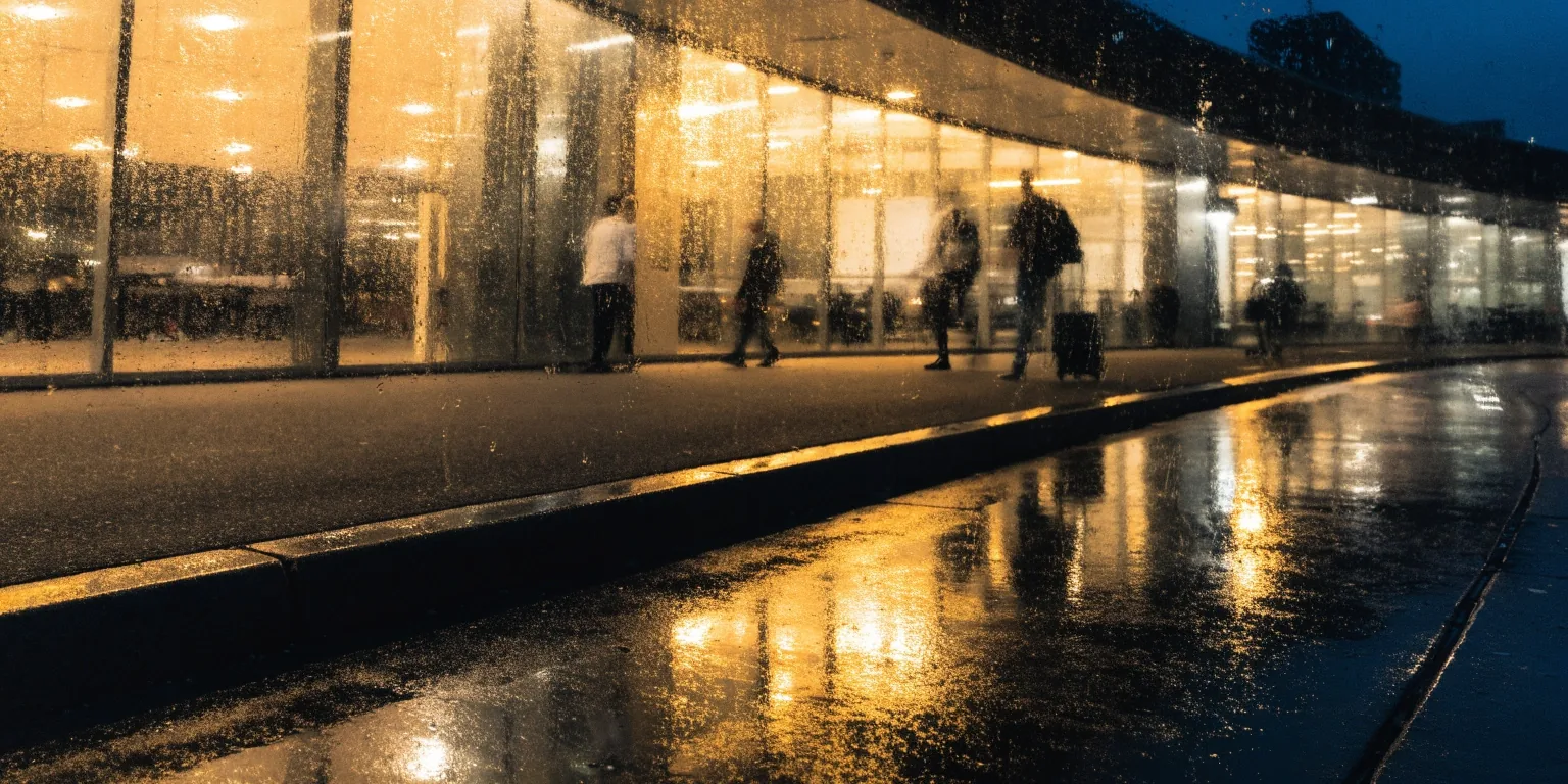 Terminal frontage at night with rain on glass
