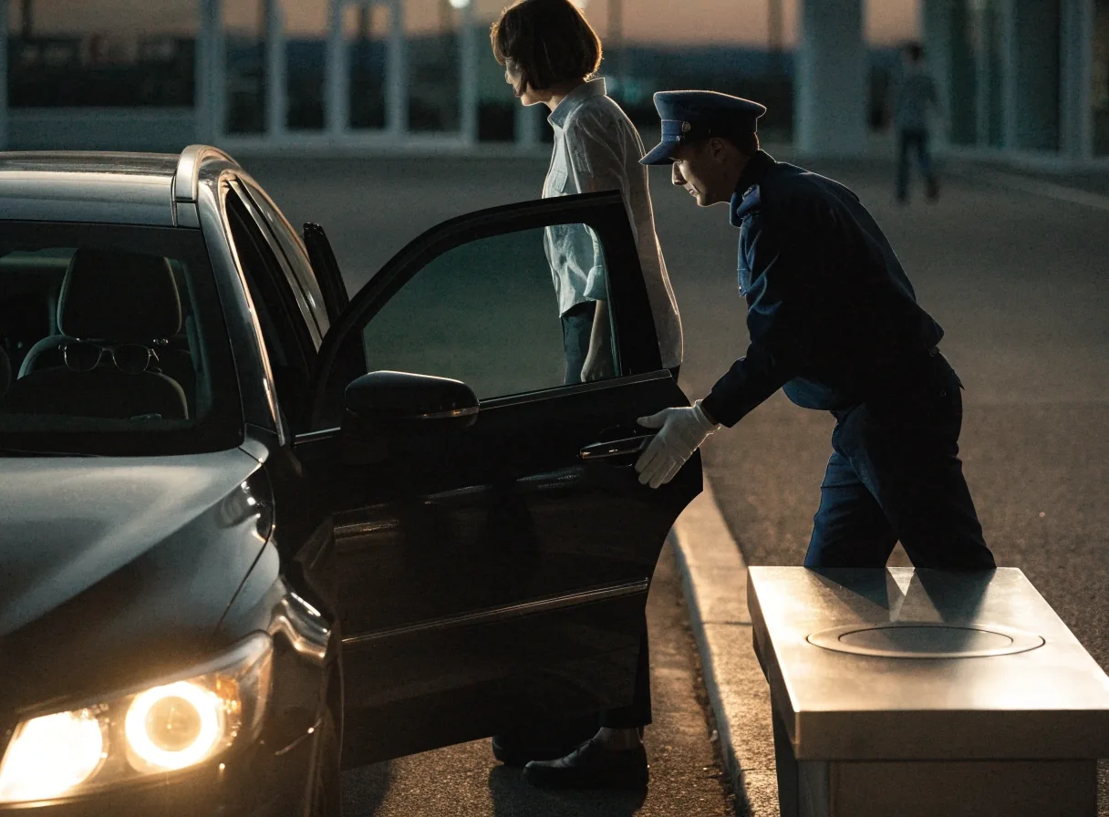 Terminal kerb lane at dusk with valet podium